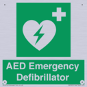 green-background-with-white-text-and-heart-defibrillator-symbol--white-cross-and~